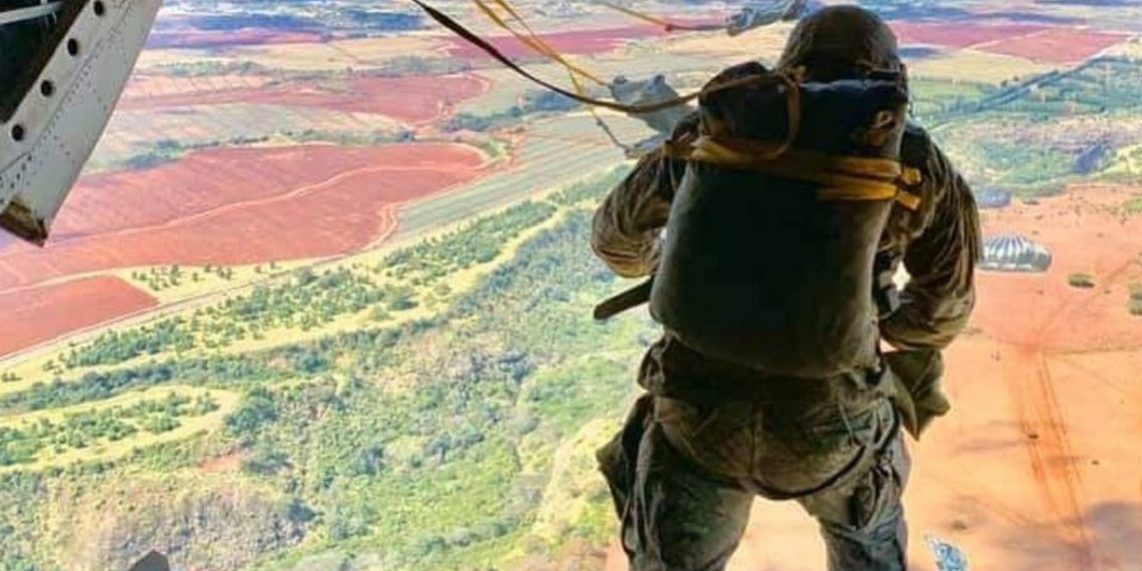 Photo of soldier looking at the horizon from a plane illustrates blog "How To Achieve CMMC Level 2 Compliance in 90 Days"