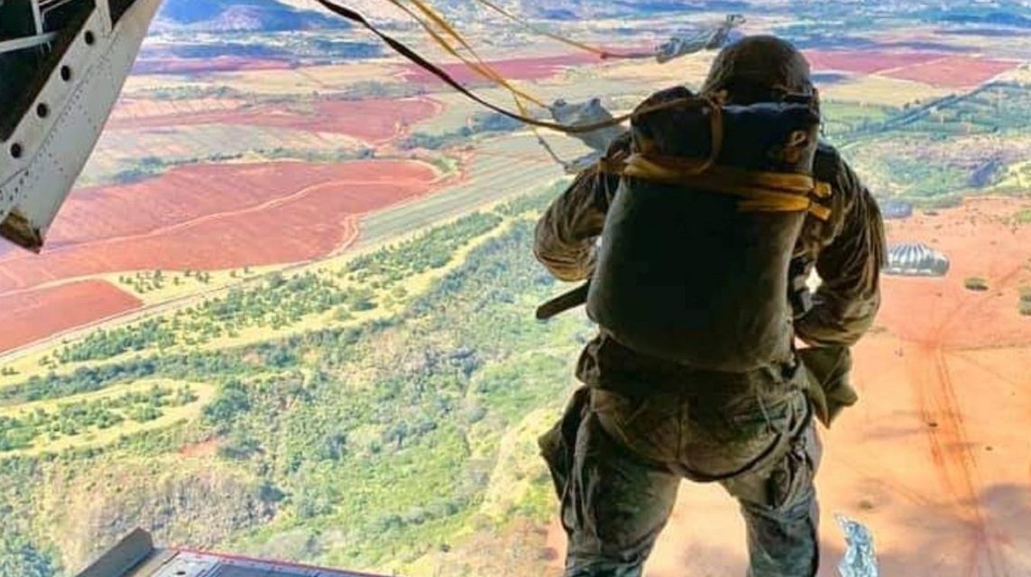 Photo of soldier looking at the horizon from a plane illustrates blog "How To Achieve CMMC Level 2 Compliance in 90 Days"