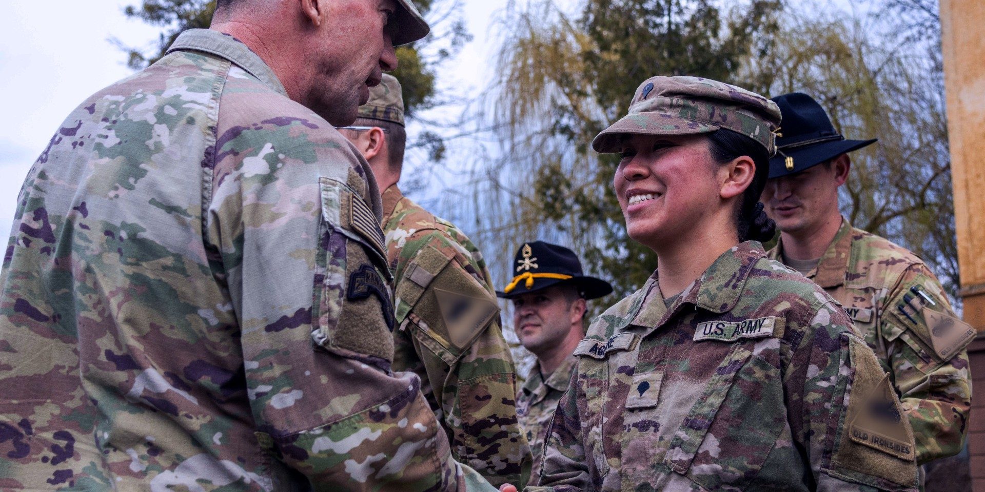 Members of the Army shaking hands illustrate blog "What Is CMMC Level 2?"