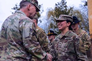 Members of the Army shaking hands illustrate blog "What Is CMMC Level 2?"