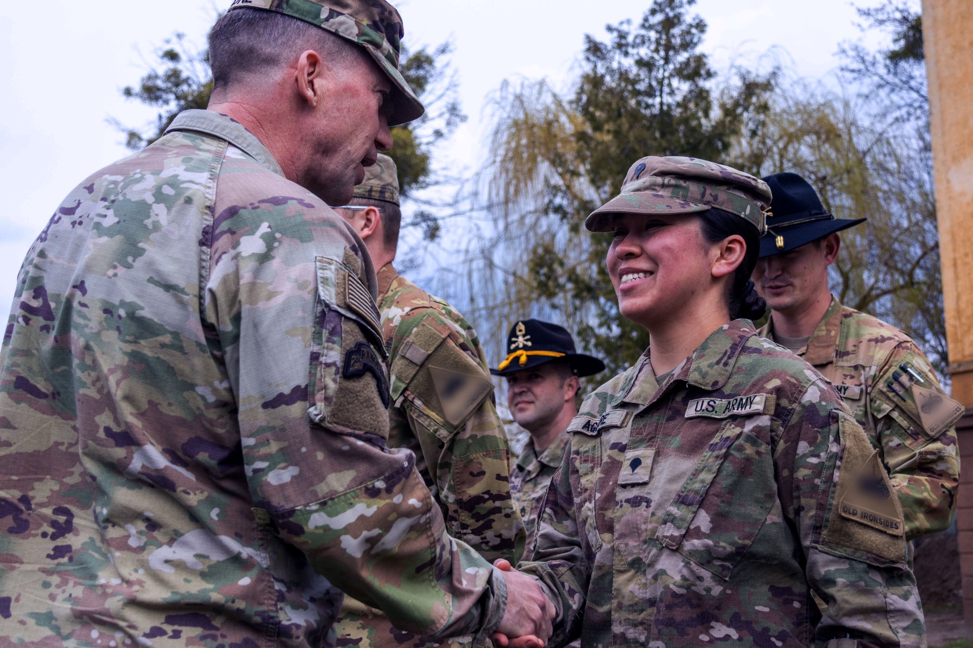 Members of the Army shaking hands illustrate blog "What Is CMMC Level 2?"