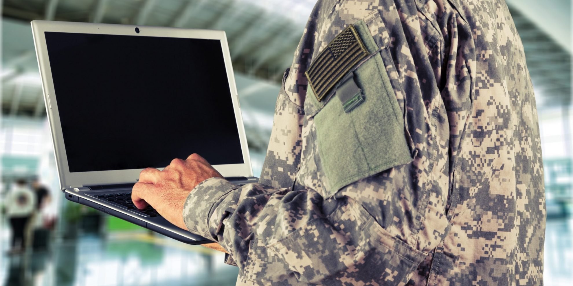 Soldier holding tablet illustrates blog "GCC High and CMMC: What You Need To Know "