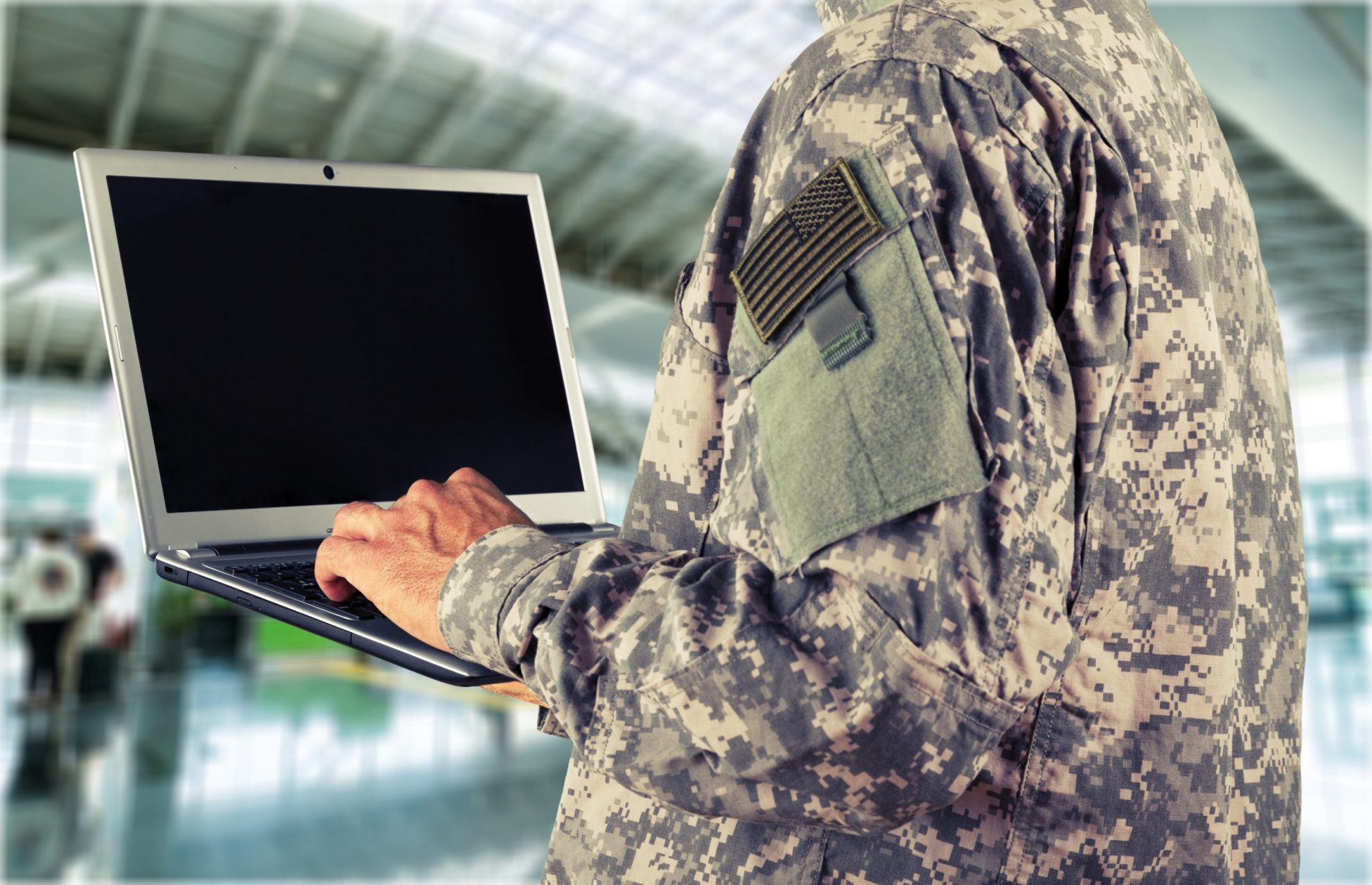 Soldier holding tablet illustrates blog "GCC High and CMMC: What You Need To Know "
