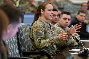 Female soldier talking illustrates blog "CMMC Compliance: What Is FIPS-Validated Cryptography? "