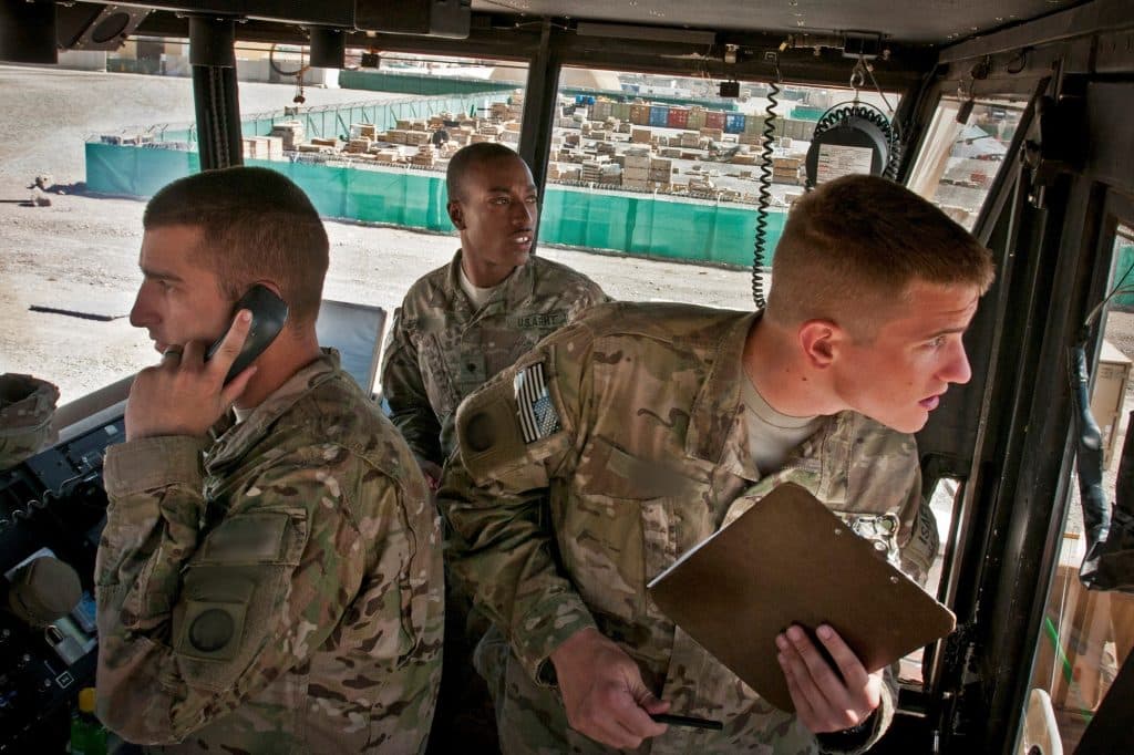 Three soldiers, one holding clipboard and another holding phone receiver illustrate blog "Is ITAR Data CUI?"