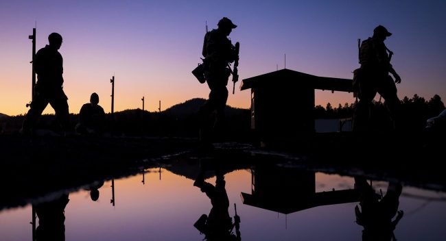 EmaiIITARData U.S. soldiers seen walking against the morning sky illustrate blog "Can You Email ITAR Data? "