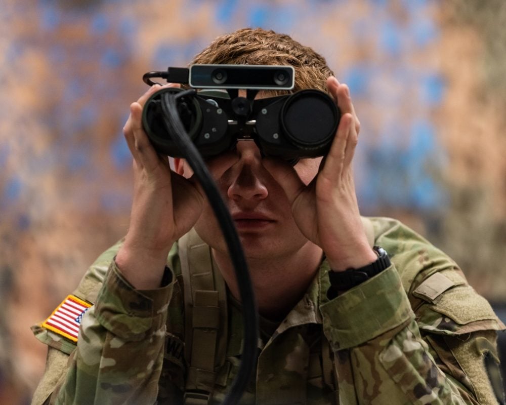 U.S soldier using binoculars illustrates blog "CMMC vs. FedRAMP: What Is the Difference? "