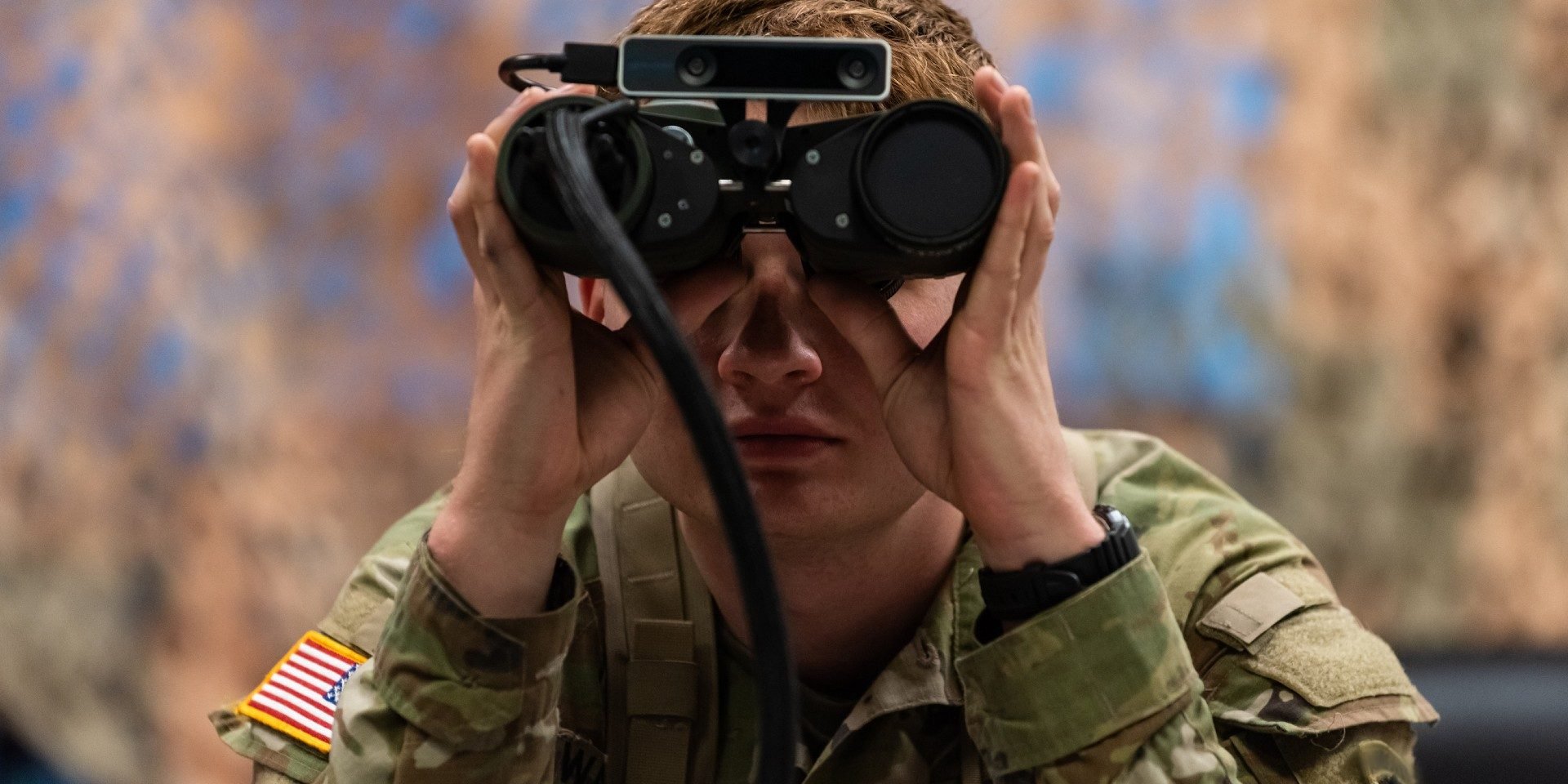 U.S soldier using binoculars illustrates blog "CMMC vs. FedRAMP: What Is the Difference? "